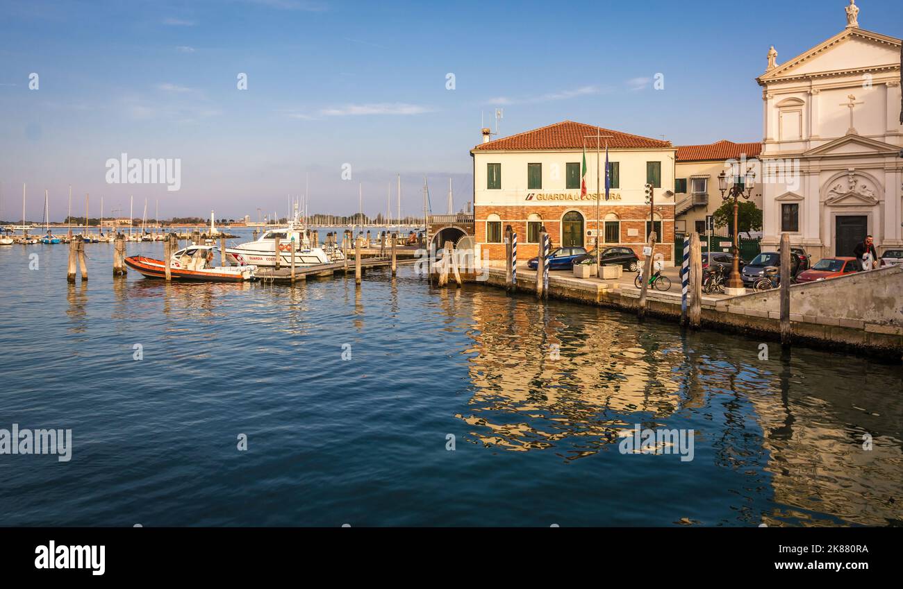 Boat of the Guardia Costiera (Italian coastguard) moored near yachts in the Harbour at Chioggia Venetian Lagoon, Veneto regione, Italy, Europe. Stock Photo