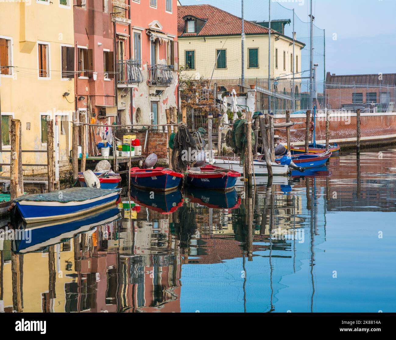 Chioggia cityscape with narrow water canal with moored boats, buildings - Venetian lagoon, Venice province, Italy Stock Photo
