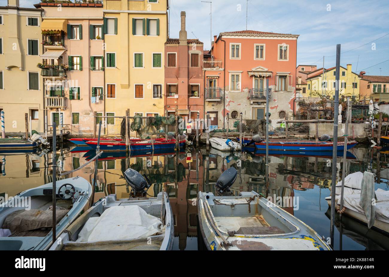 Chioggia cityscape with narrow water canal with moored boats, buildings - Venetian lagoon, Venice province, Italy Stock Photo