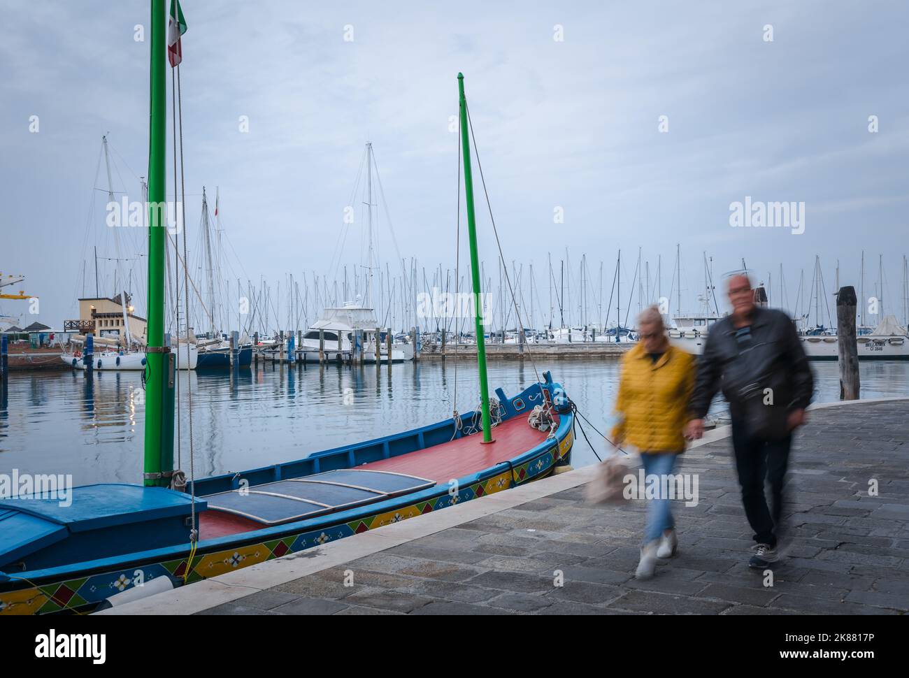 Tourists  working on the Harbour waterfront - Chioggia Venetian Lagoon, Veneto regione, Italy, Europe- long exposure Stock Photo