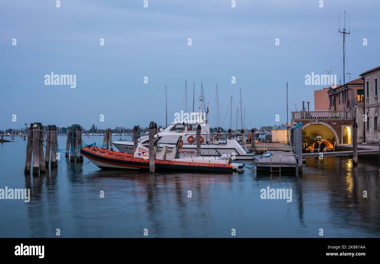 Boat of the Guardia Costiera (Italian coastguard) moored near yachts in the Harbour at Chioggia Venetian Lagoon, Veneto regione, northern italy Stock Photo