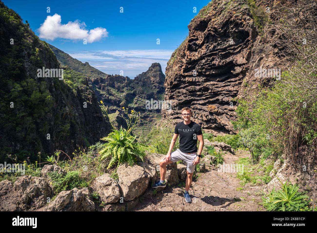 A Caucasian male hiker on top of a mountain during sunset in Masca, Tenerife, Spain Stock Photo