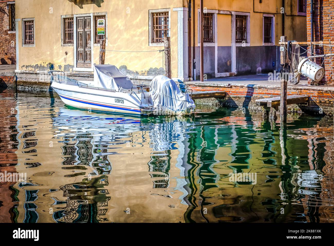 motorboat moored along the canal in Chioggia city, Venetian lagoon, Venice province, Veneto district, northern Italy - Europe Stock Photo