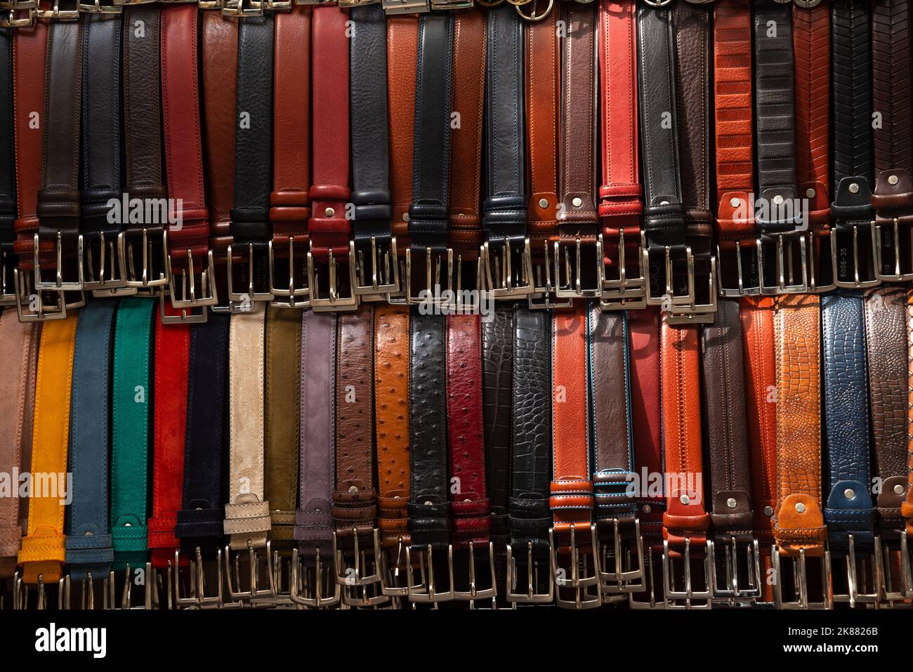 Colorful different leather belts background. Made in Italy Stock Photo