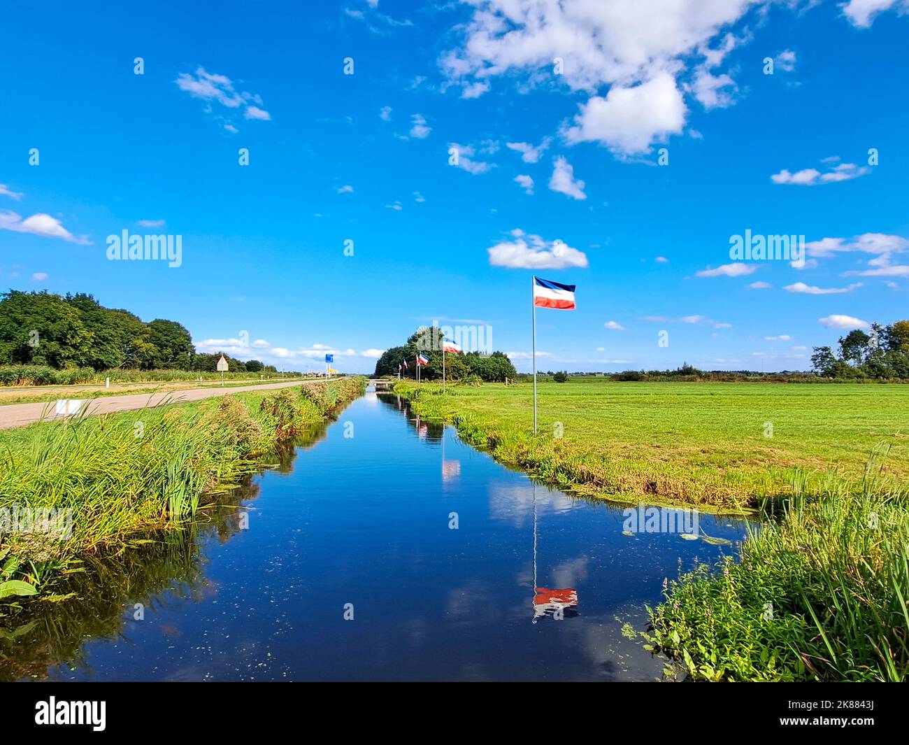 Protest signs and rows of flags upside down in Lekkerkerk along the