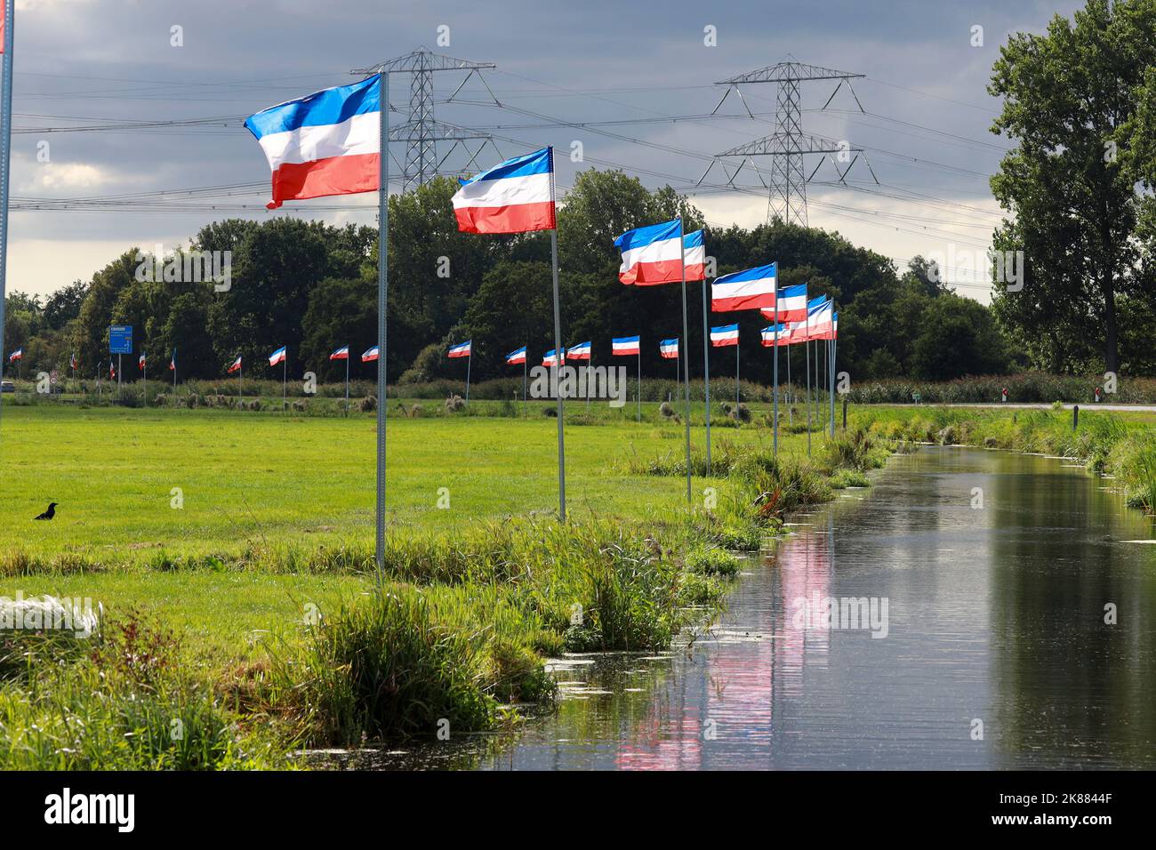 Protest signs and rows of flags upside down in Lekkerkerk along the