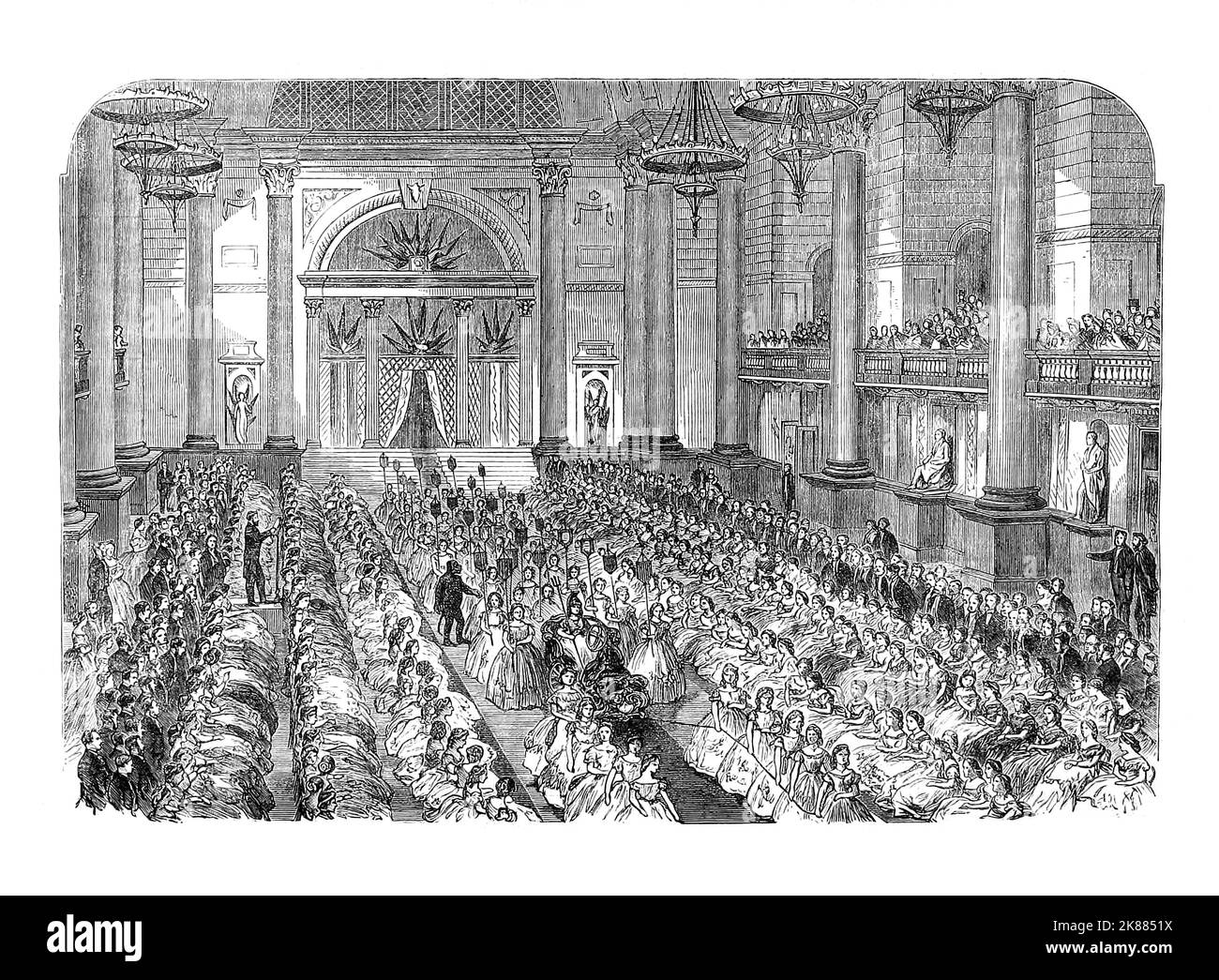 A Christmas party in St George's Hall laid on in 1864, for the staff of Cope Bros & Co was a company based in Liverpool that manufactured tobacco products from 1848 until 1952. By the 1880s the company, employing nearly 2000 staff and producing multiple brands of snuff, cigars, cigarettes and tobacco employed mainly women and girls and was regarded by local press to be a model employer of the age with better working conditions than other employers. Stock Photo