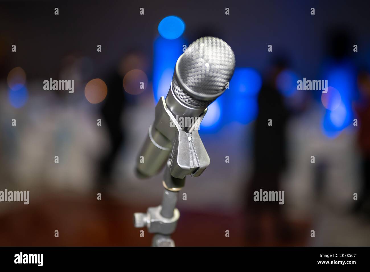 The close-up view of a silver microphone on a stand before the blurred background Stock Photo