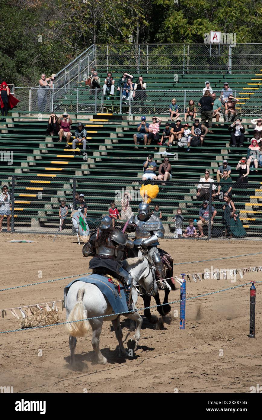 Folsom, CA, September 24, 2022. Jousting match between knights a white horse and black horse at the Folsom Renaissance Faire. This fun historical fest Stock Photo