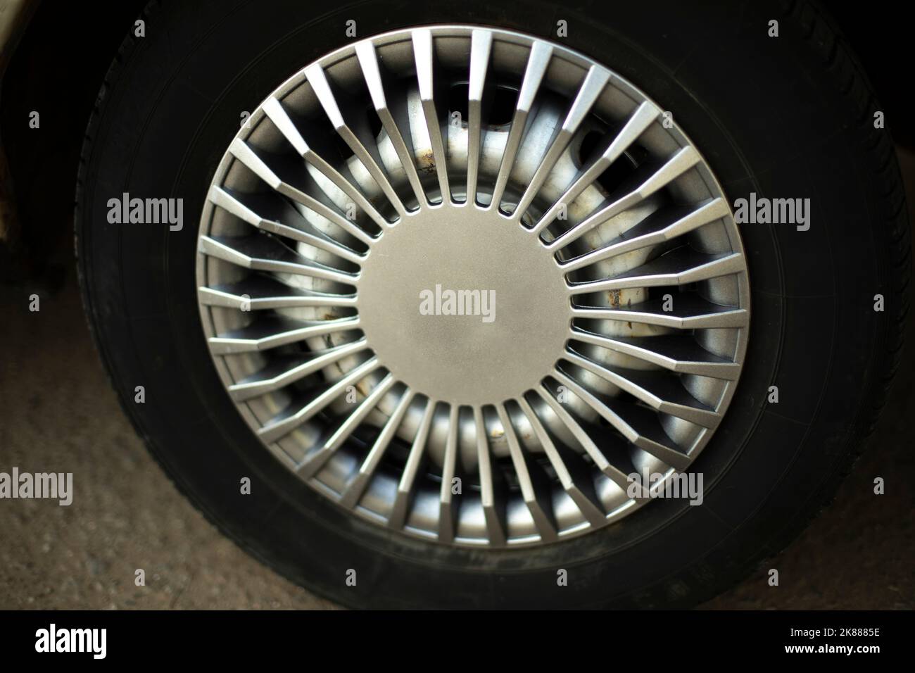 Car wheel. Hubcap on wheel. Vehicle tuning details. Drive wheel. Retro style. Black tire. Stock Photo