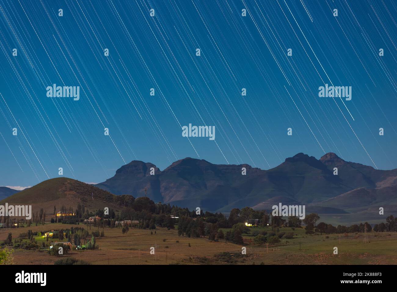 Star trails above the mountains in the town of Clarens, South Africa. This popular tourist destination is near the Golden Gate Highlands National Park Stock Photo