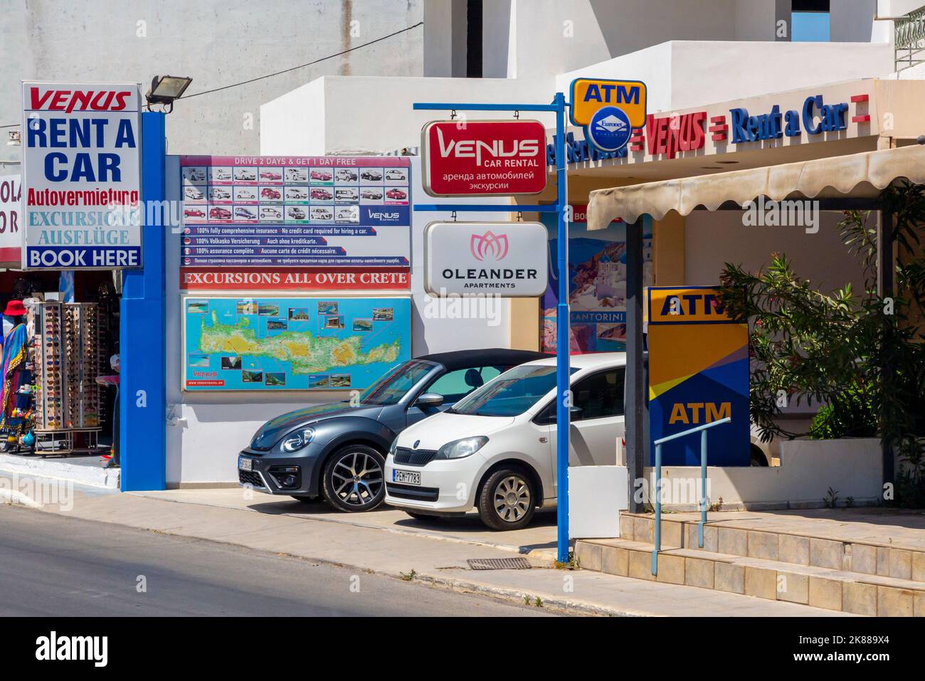 Car rental shop near the beach at Platanias near Rethymno or Rethymnon a resort town on the coast of northern Crete in Greece. Stock Photo