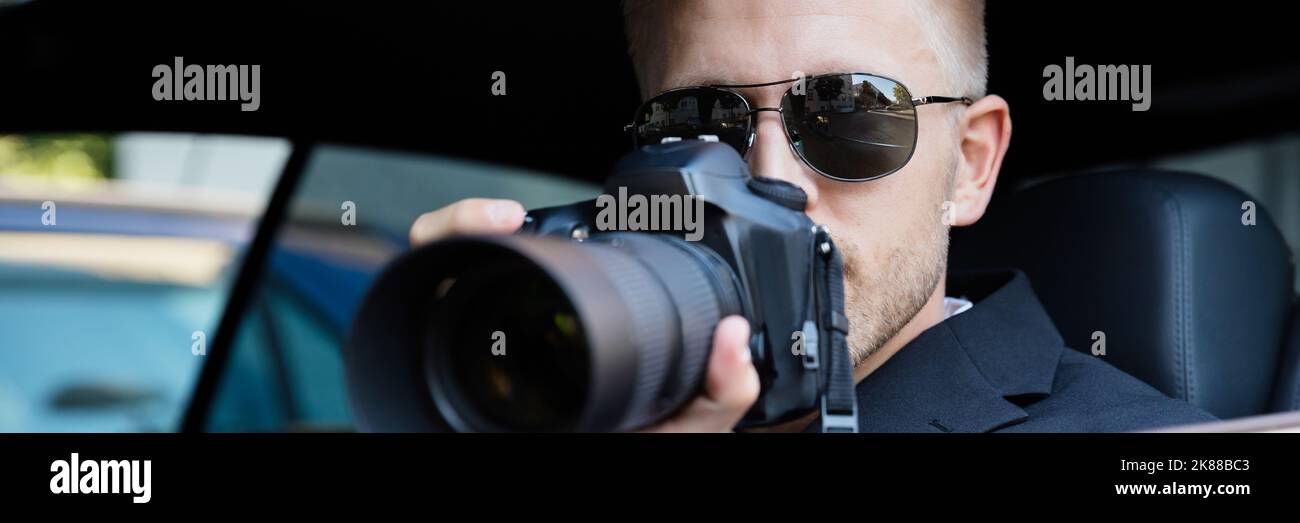 Private Detective Investigator. Undercover Spy with Camera Stock Photo