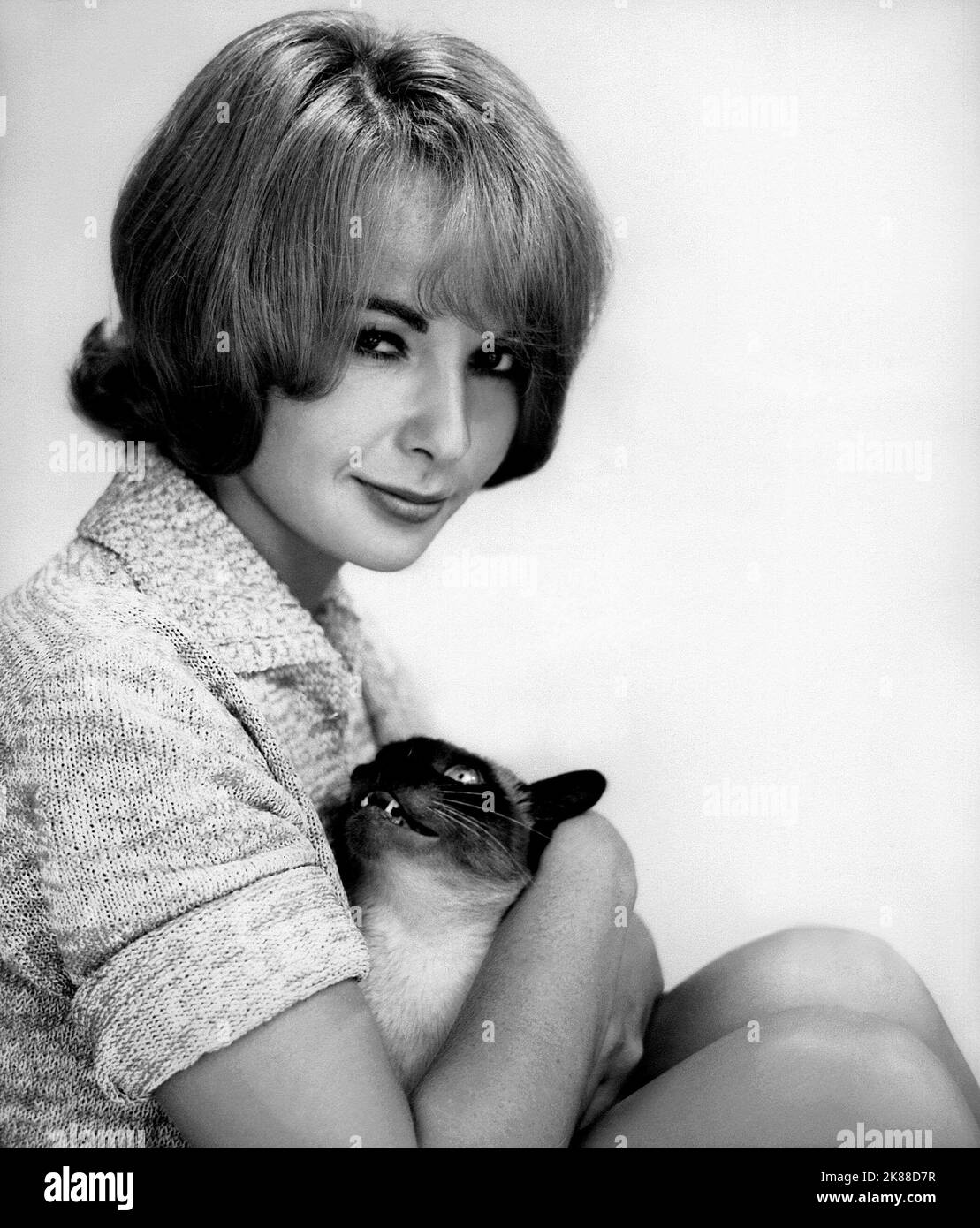Francoise Arnoul & Cat  Actress   01 May 1957   **WARNING** This Photograph is for editorial use only and is the copyright of The Film Company and/or the Photographer assigned by the Film or Production Company and can only be reproduced by publications in conjunction with the promotion of the above Film. A Mandatory Credit To The Film Company is required. The Photographer should also be credited when known. No commercial use can be granted without written authority from the Film Company. Stock Photo