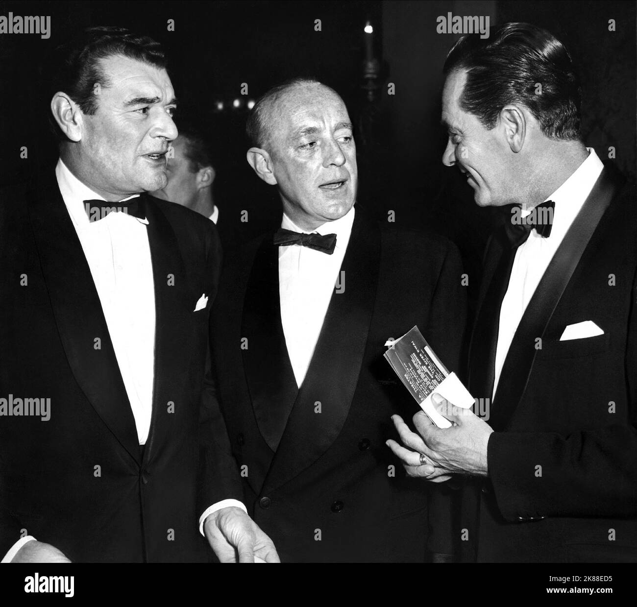 Jack Hawkins, Alec Guinness & William Holden  The Bridge On The River Kwai Premiere   02 October 1957   **WARNING** This Photograph is for editorial use only and is the copyright of LONDON and/or the Photographer assigned by the Film or Production Company and can only be reproduced by publications in conjunction with the promotion of the above Film. A Mandatory Credit To LONDON is required. The Photographer should also be credited when known. No commercial use can be granted without written authority from the Film Company. Stock Photo