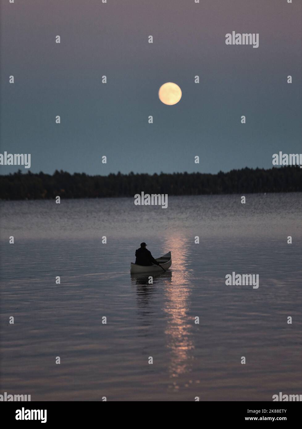 A solitary canoe paddle under a full moon in Maine Stock Photo Alamy