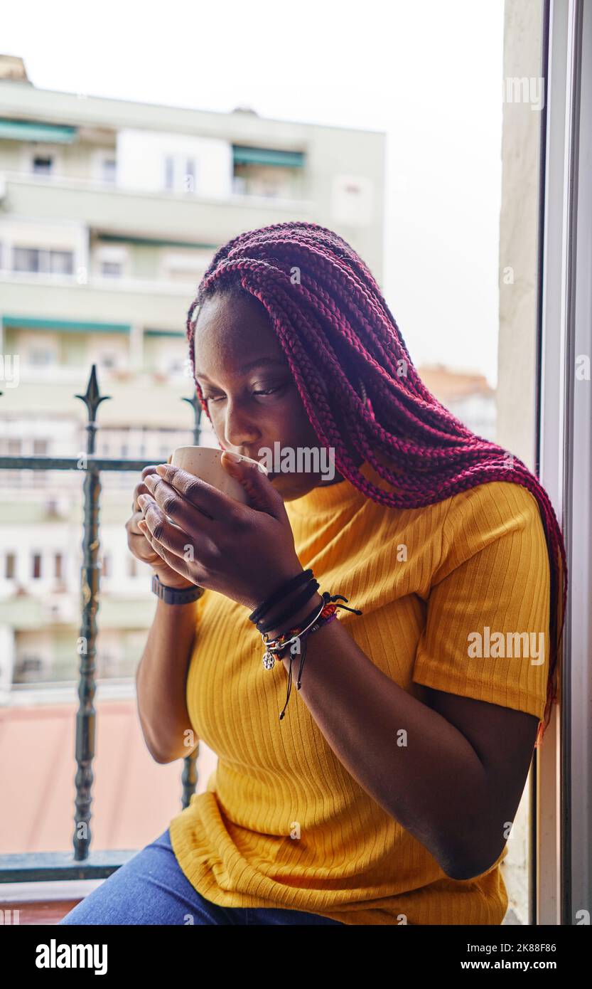 african american woman drinking coffee sitting at kitchen window Stock ...