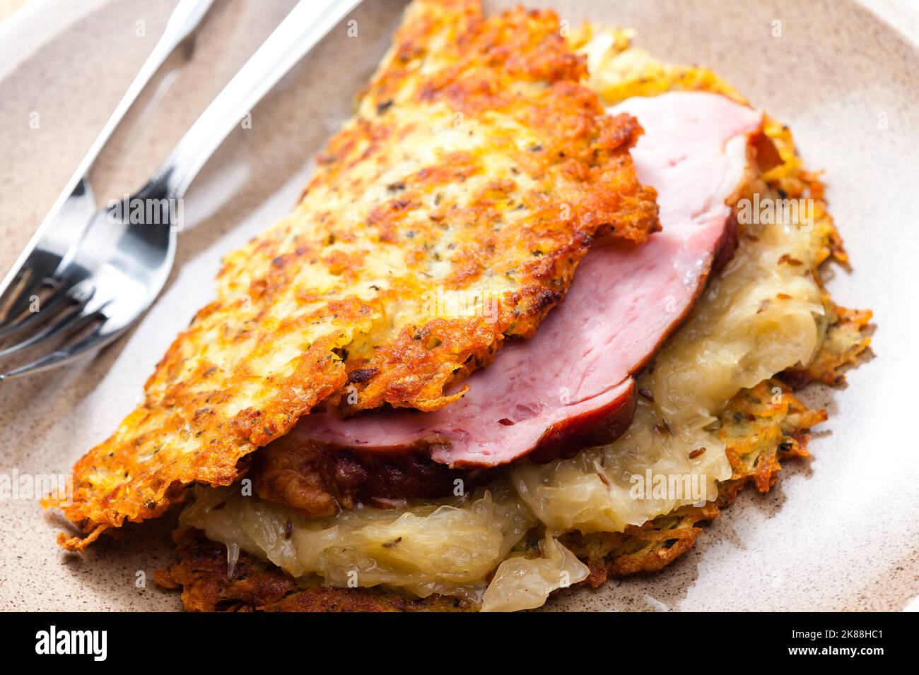 potato cakes with smoked meat and sour cabbage Stock Photo Alamy