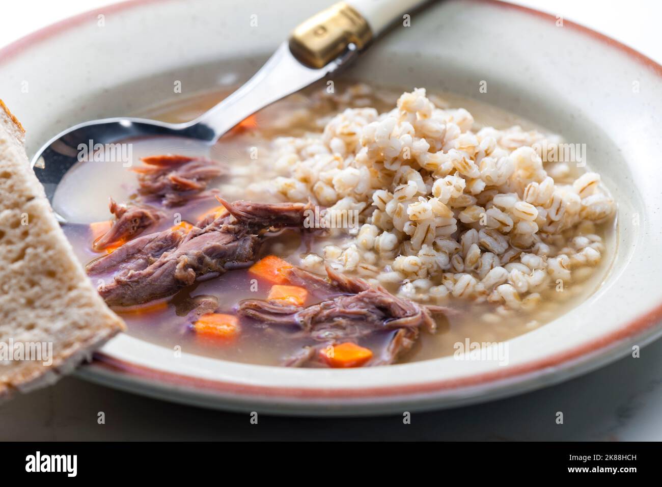 beef broth with carrot and barley groats Stock Photo Alamy