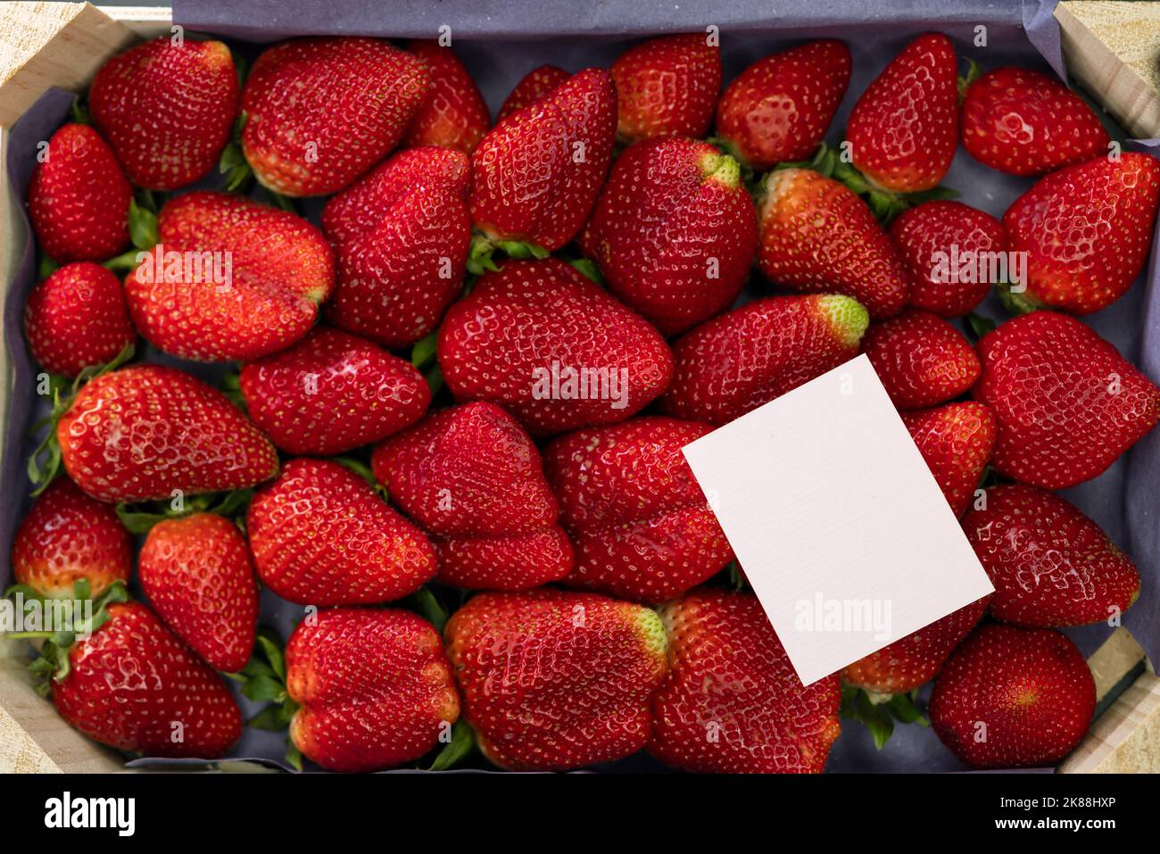 still life of strawberries with a label for text Stock Photo - Alamy
