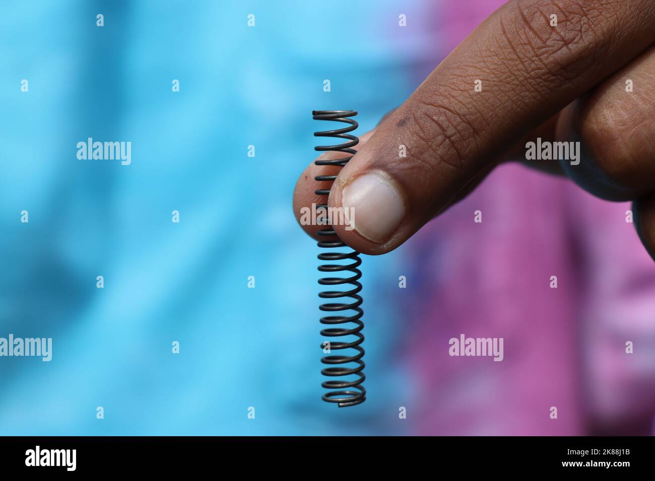 Compression springs made of metal holding in hand, Metal springs are