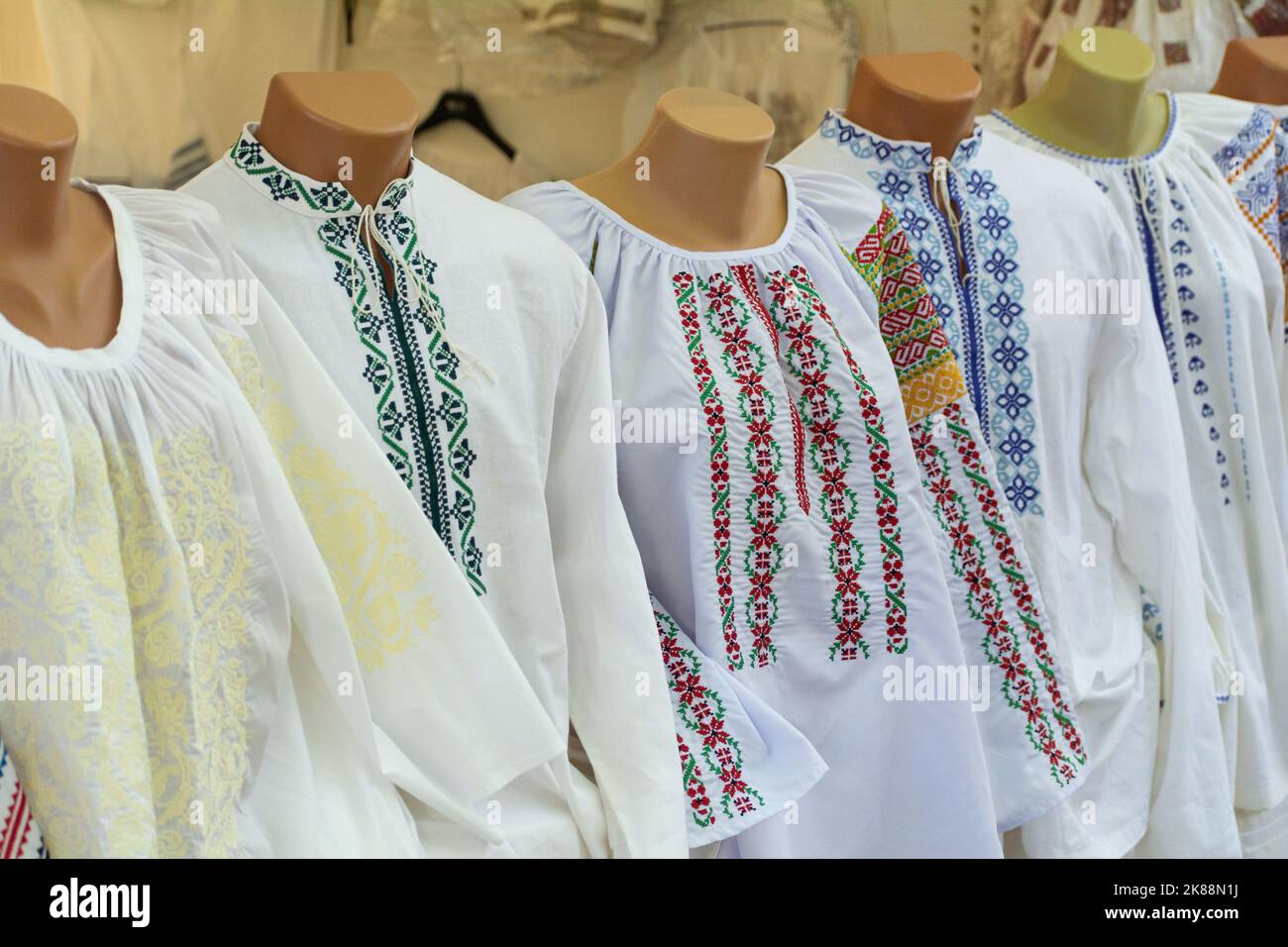 Moldovan embroideries. Men's and women's Moldovan embroidered shirts at the fair. Balkan embroidered national traditional costume clothes Stock Photo