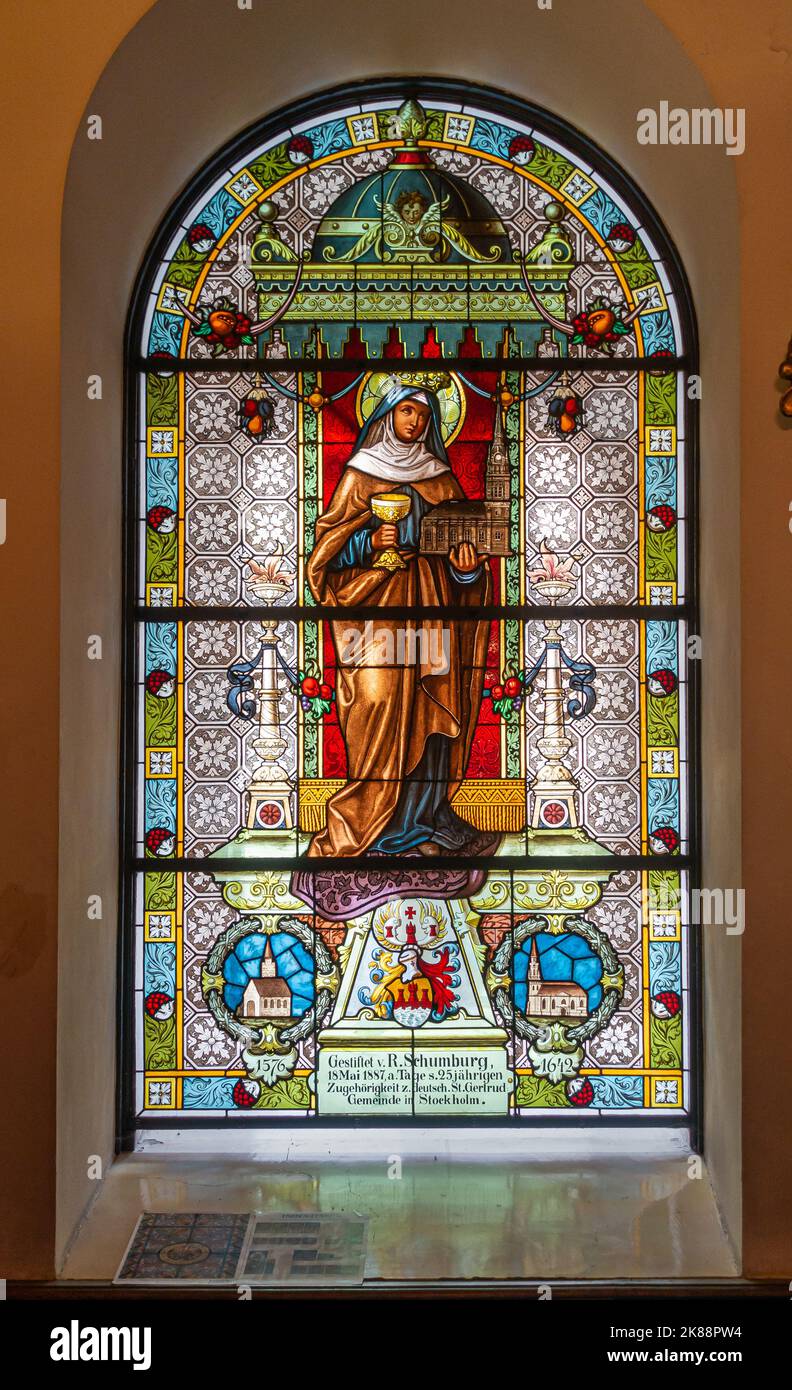 https://c8.alamy.com/comp/2K88PW4/sweden-stockholm-july-16-2022-gamla-stan-colorful-stained-glass-window-in-arch-at-st-gertrude-church-featuring-image-of-her-2K88PW4.jpg