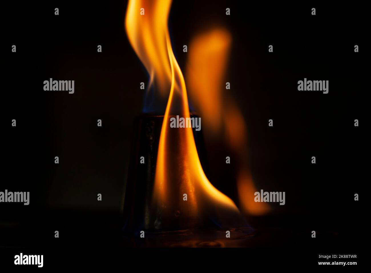 Flames in dark. One flame on black background. Ignition details. Fire