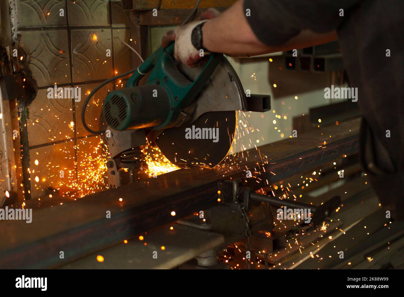 Sawing steel. Circular saw and sparks. Production details. Metal