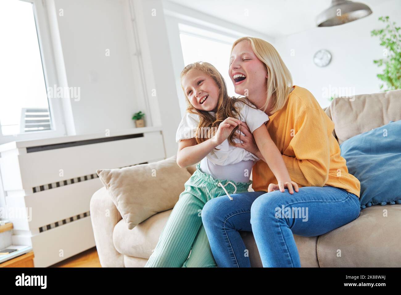 child sister fun family girl together childhood female happy daughter young lifestyle home indoor happiness kid togetherness mother woman Stock Photo