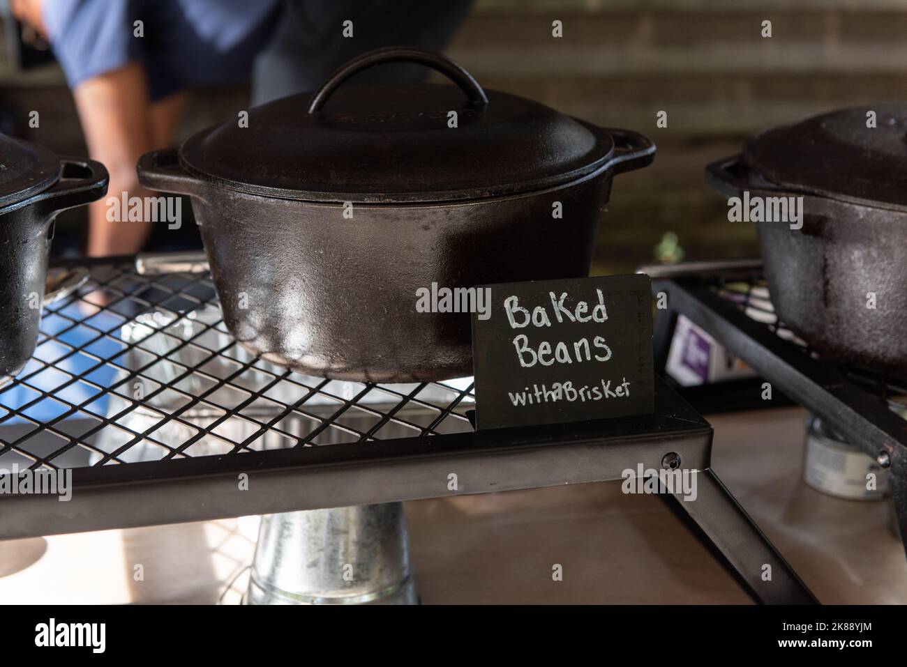 Buffet line has a cast iron pot of baked beans for the guests to serve