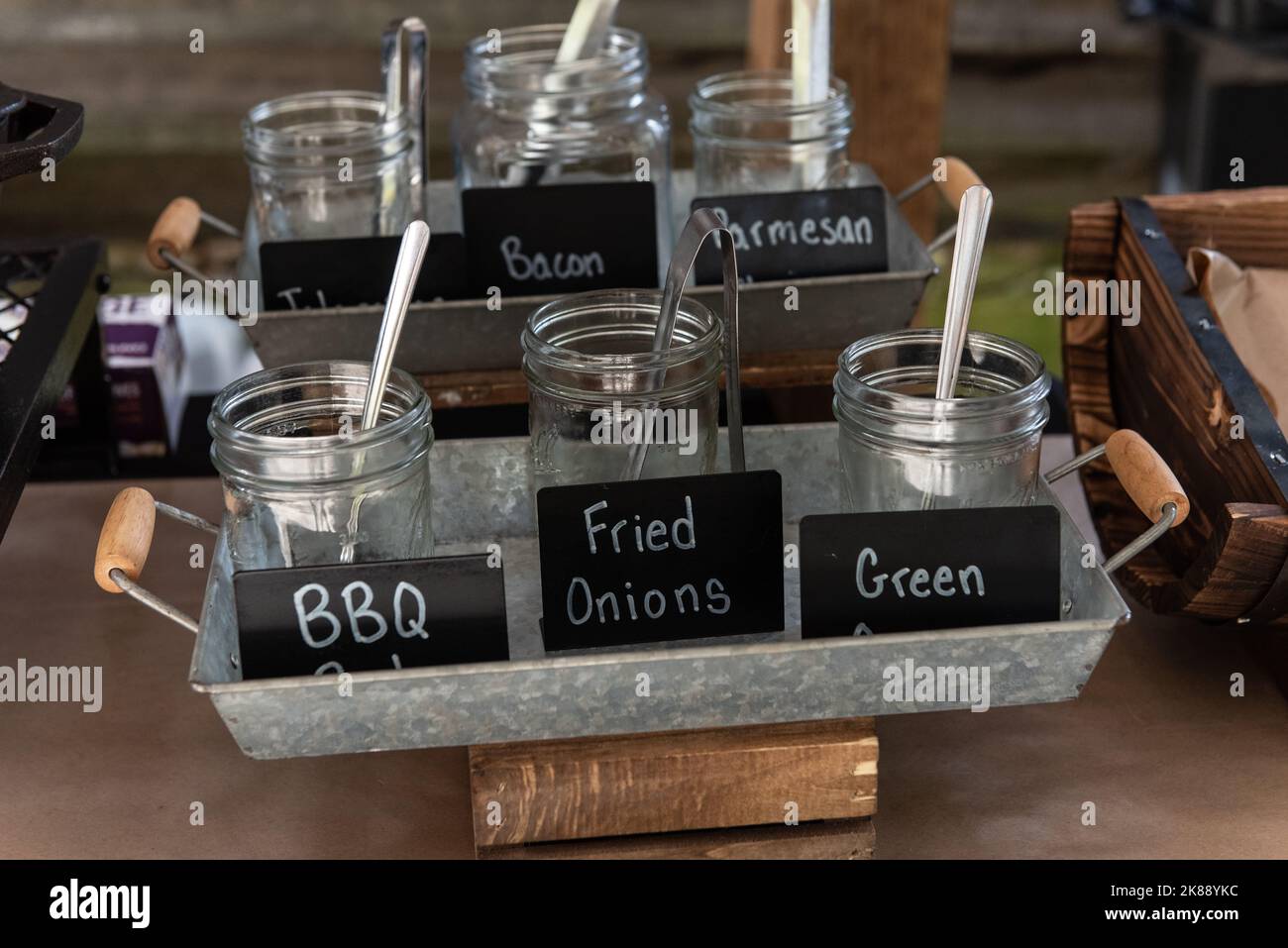 Buffet line has a glass jars of all the garnishments and toppings for ...