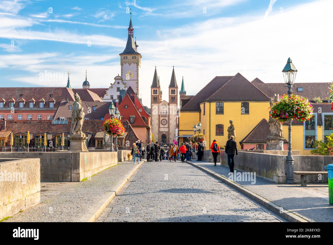 Old Main bridge with statues of holy figures and the the towers Grafeneckart and St. Kiliansdom, in the Bavarian city of Würzburg, Germany. Stock Photo