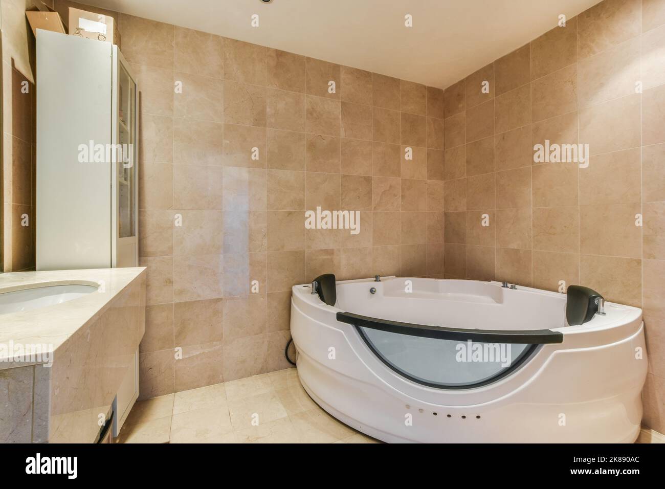 Modern home interior design of light bathroom with white ceramic tiles and bathtub with shower