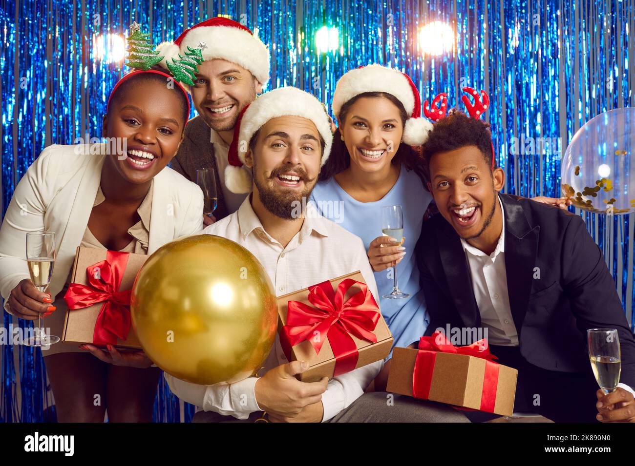 Portrait of cheerful young multiracial people having fun together at New Year's party. Stock Photo