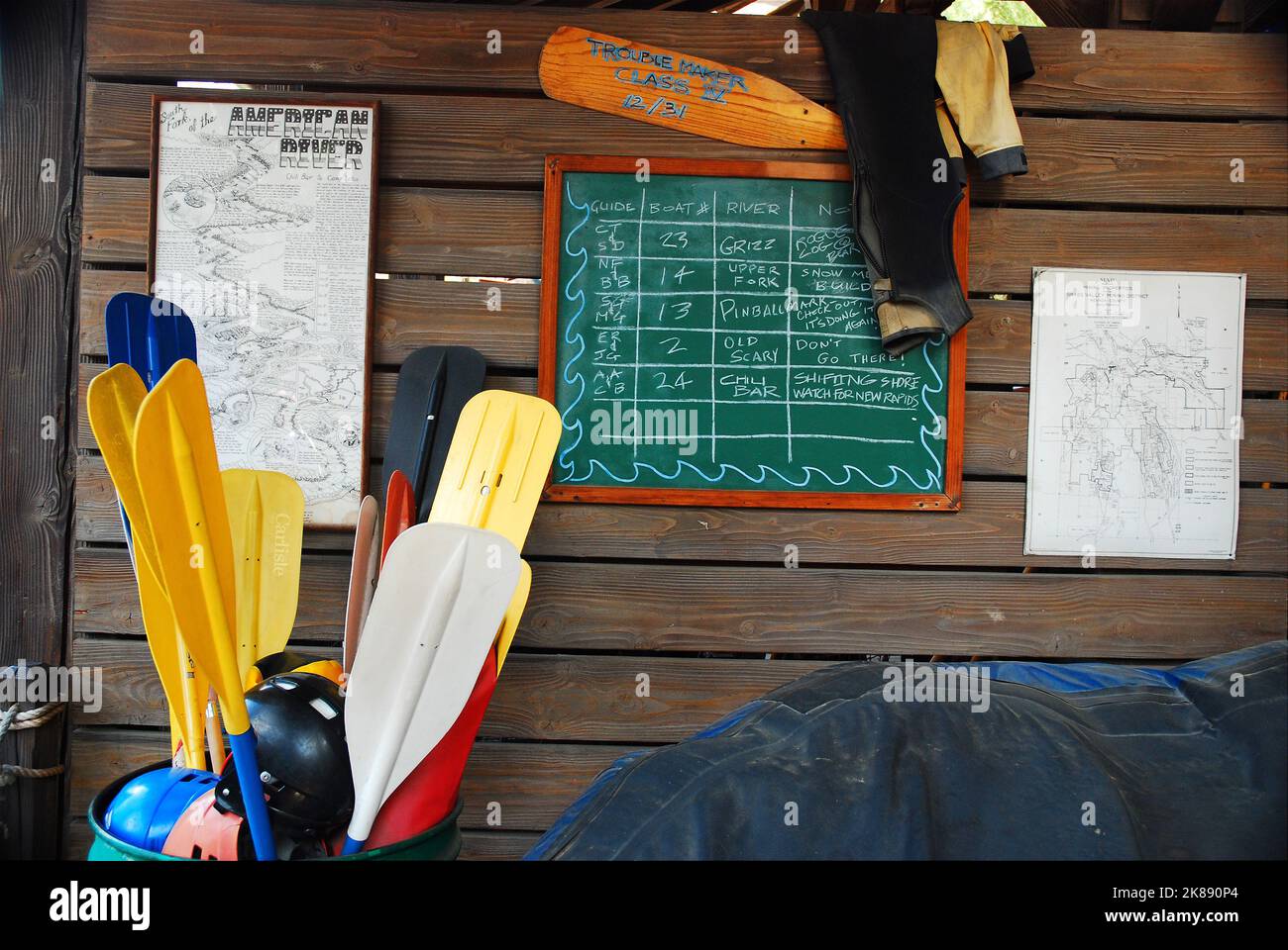 Oars sit in a barrel, of an adventure company and outfitter, ready to be used on a white water rafting trip Stock Photo