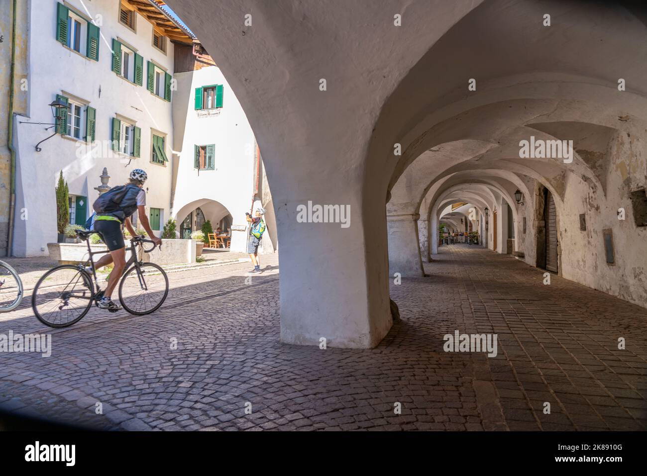 The town of Neumarkt, in the Adige Valley, in South Tyrol, arcades in the old town, in front of shops and restaurants, Italy Stock Photo