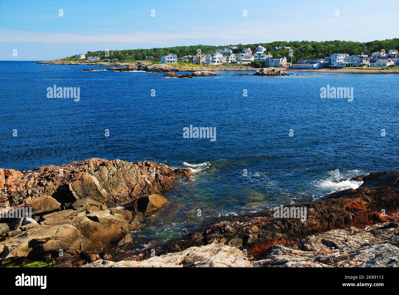 The rocky coast of Maine meets the sea at Perkins Cove with summer
