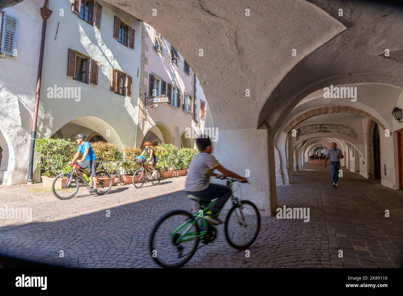 The town of Neumarkt, in the Adige Valley, in South Tyrol, arcades in the old town, in front of shops and restaurants, Italy Stock Photo