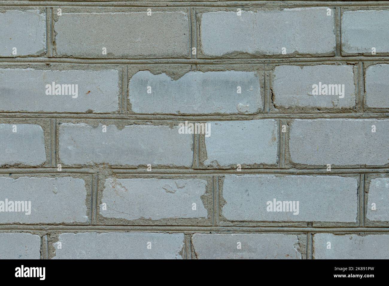 White brick wall made from used material. Abstract texture background image Stock Photo