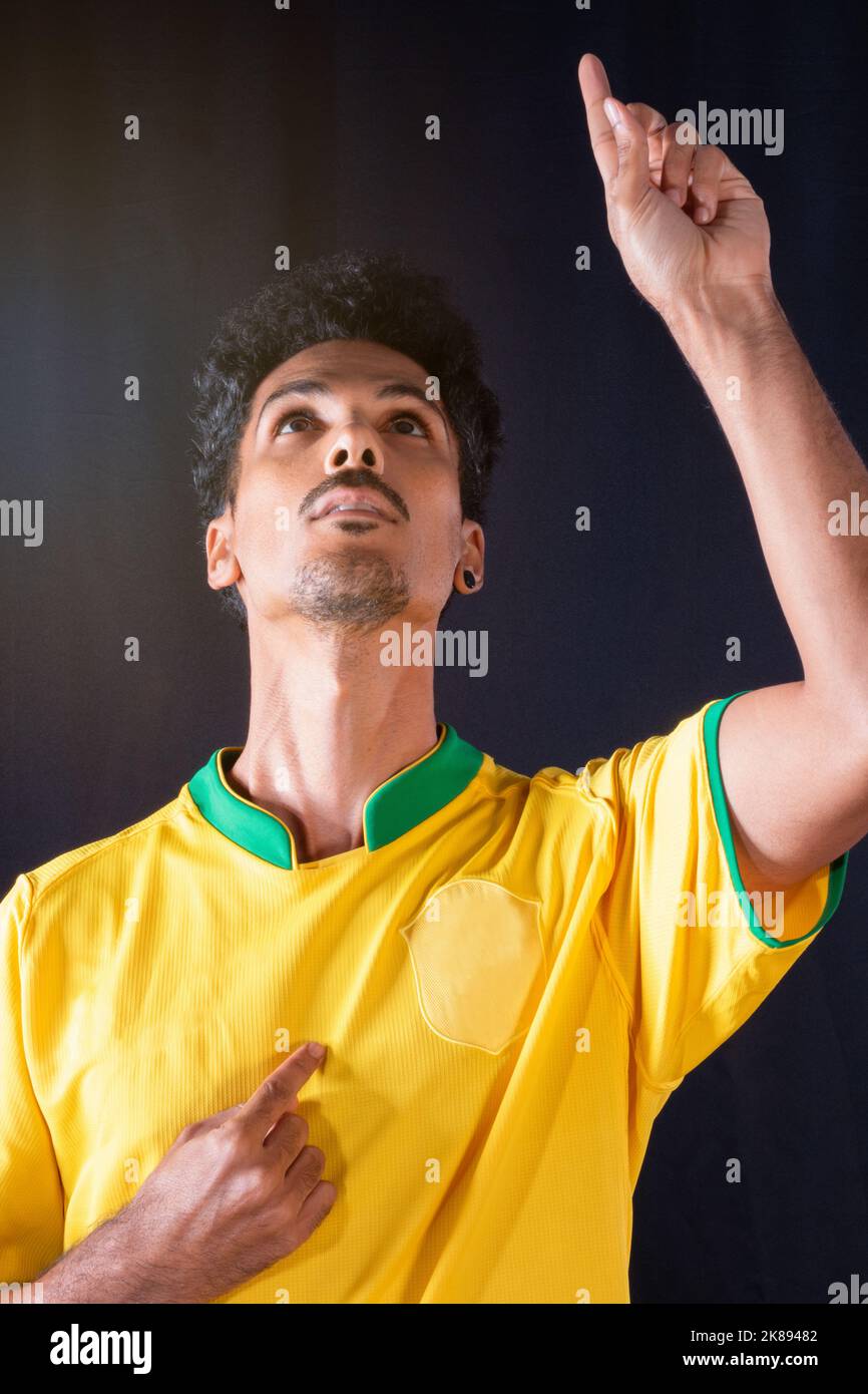 Brazilian Football Black Player Celebrating, Isolated on Black Background. Stock Photo