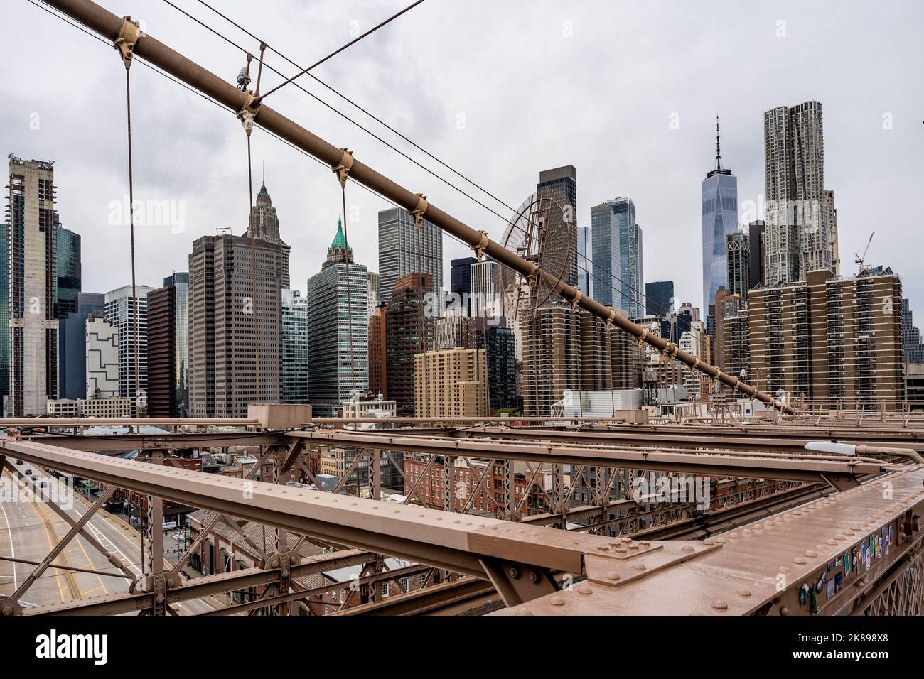 Lower Manhattan seen from the Brooklyn Bridge, New York City, with ropes in foreground Stock Photo