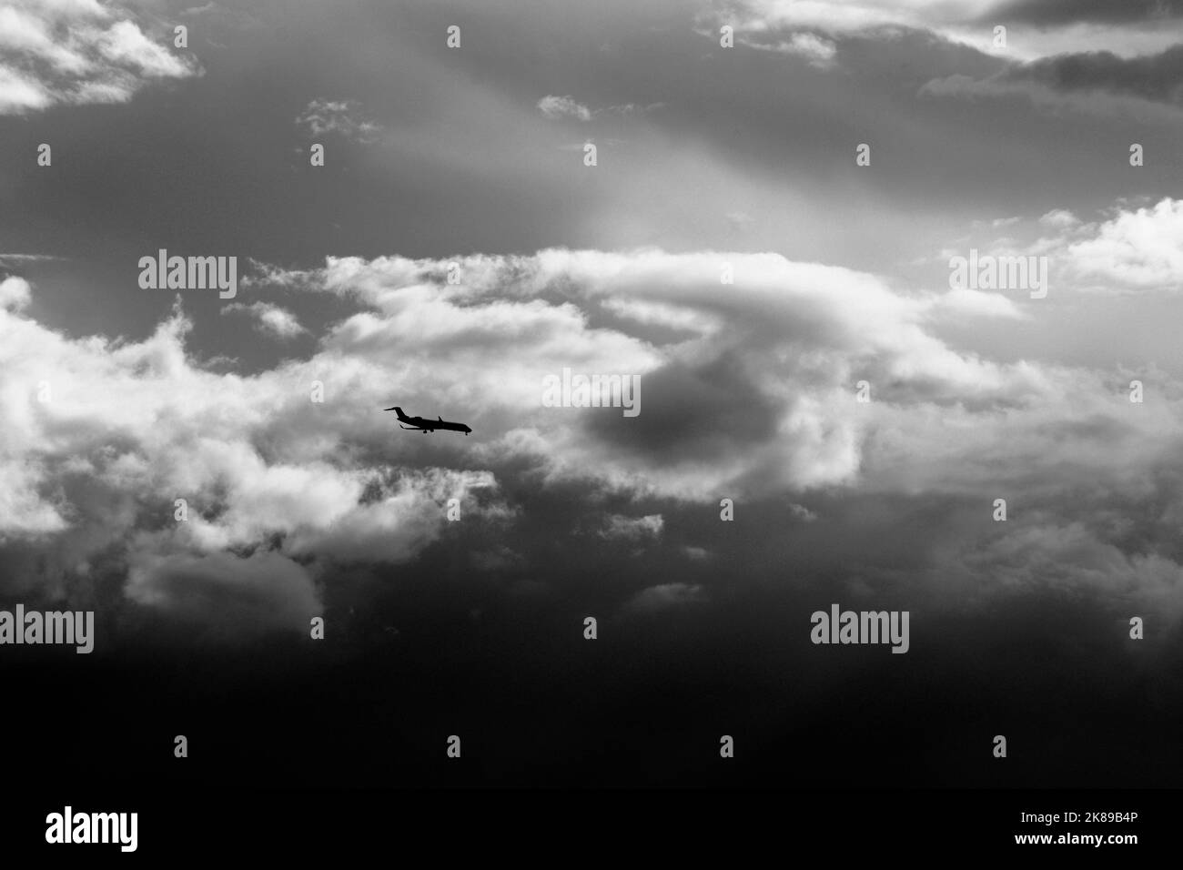 A passenger jet aircraft approaches a landing at Santa Fe Municipal Airport in Santa Fe, New Mexico. Stock Photo