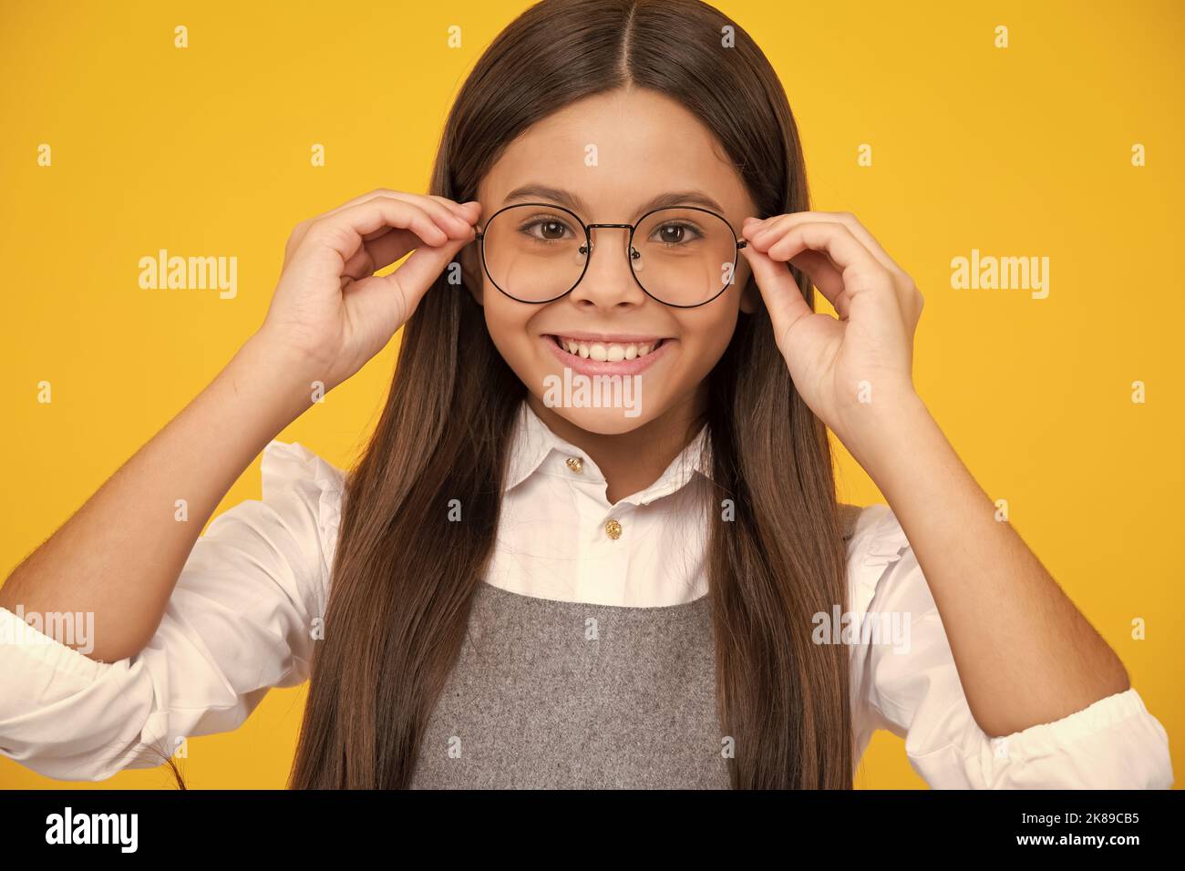 Portrait of teenager child in glasses. Kid at eye sight test. Girl