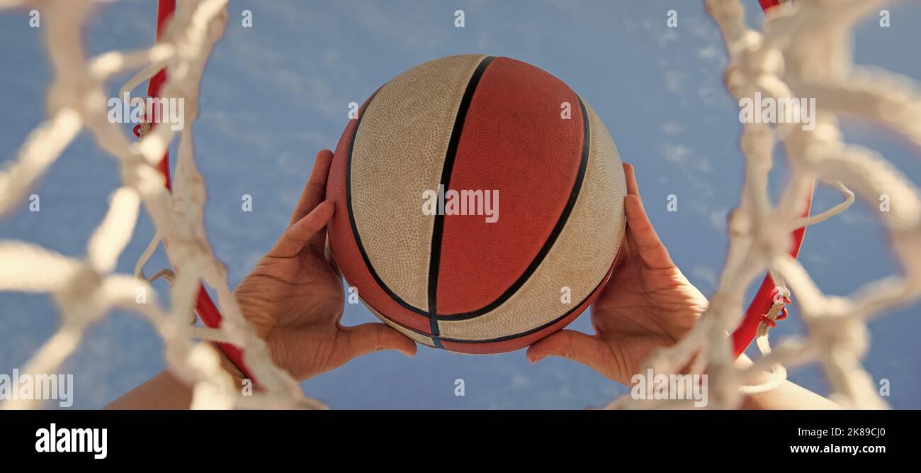 basketball ball flying through basket in players hands, sport