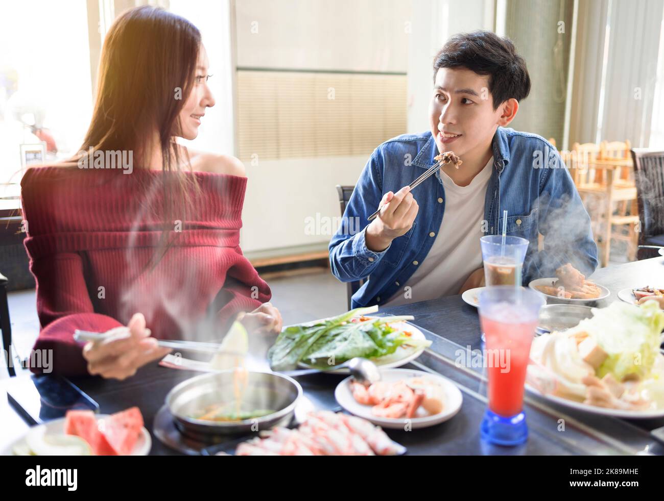 Happy young friends have dinner  in the hot pot restaurant Stock Photo