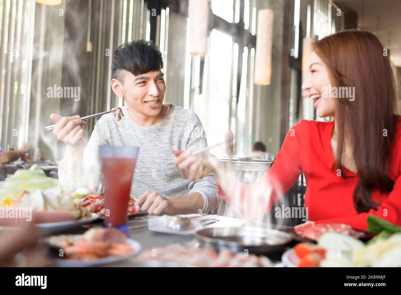 Happy young couple have dinner  in the hot pot restaurant Stock Photo