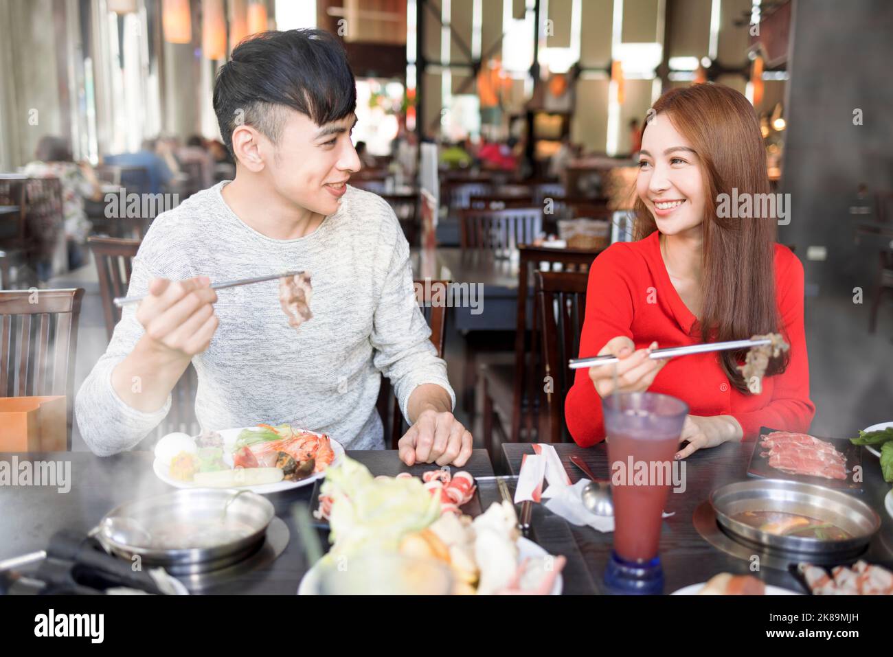 Happy young couple have dinner  in the hot pot restaurant Stock Photo