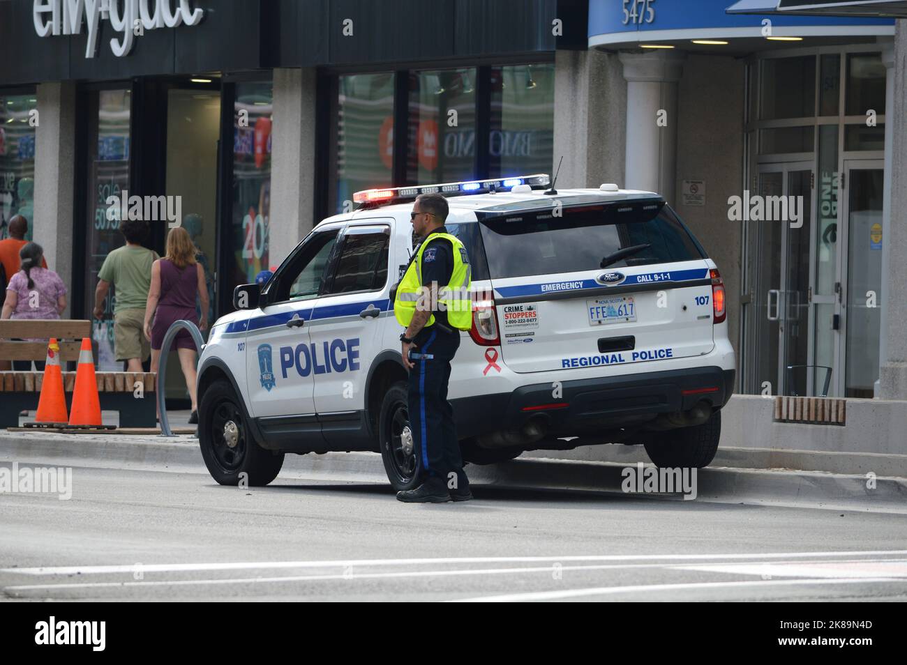 Halifax Regional Police officer and vehicle on Spring Garden Road shopping street in Halifax, Nova Scotia, Canada Stock Photo