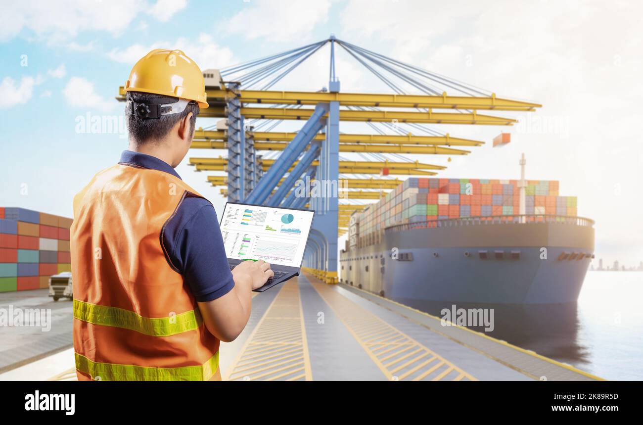 Engineer or asian worker work with computer notebook at container terminal port Stock Photo